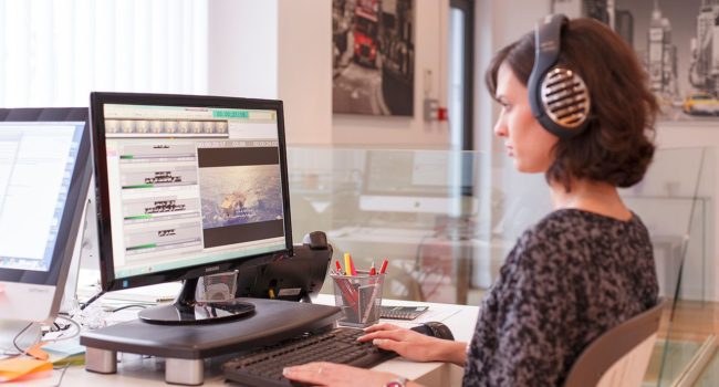 The image depicts a subtitling professional subtitling audio-visual media